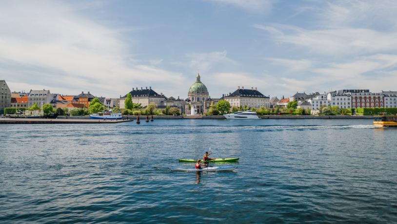 Kayaks in front of Amalienborg Castle in the harbour of Copenhagen, Denmark