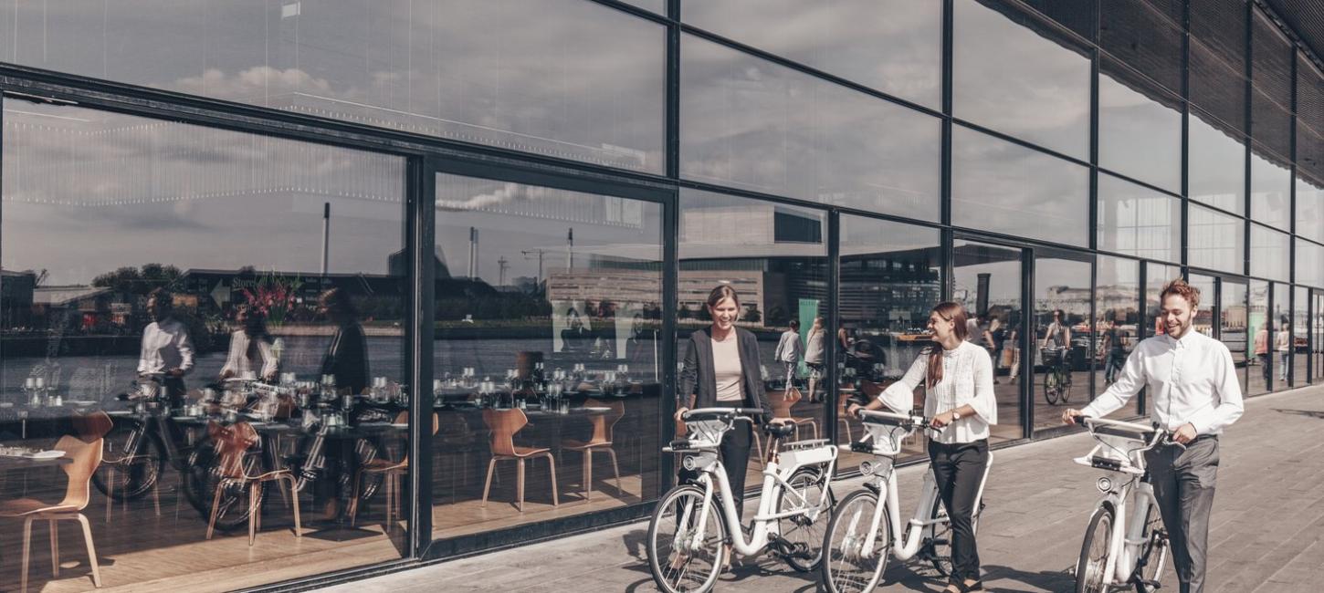 People walking outside the Royal Danish Playhouse "Skuespilhuset" with city bikes, Copenhagen