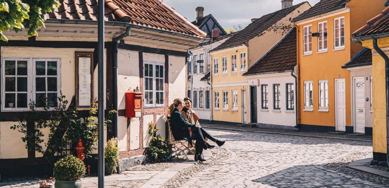 Women sitting on a bench in old town of Odense on Fyn