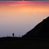 A hiker enjoying the view and sunset over Limfjorden from Hanklit on Mors.