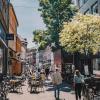 A couple stroll the streets of Odense in summer