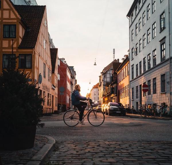 Girl biking in the neighbourhood of Christianshavn in Copenhagen