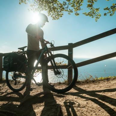 Man with bike on the edge of Møns Klint cliff